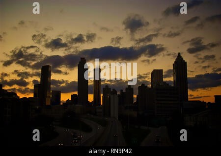 Eine dramatische Silhouette der Skyline von Georgia in Atlanta, die in einem goldenen Sonnenuntergang auftaucht. Stockfoto