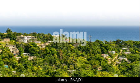 Antenne Landschaft und Blick auf den Ozean auf Wohnungen/Häuser in der Coastal Mountains, einer karibischen Insel. Saint Ann/St Ann Jamaika. Stockfoto