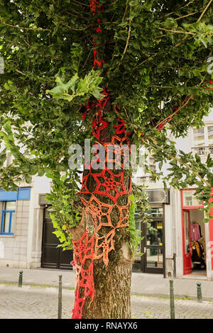 Garn Bombardierung - Urban Street Art Baumstämme mit eingerichtet (gekleidet in) Wunderschön gestrickt Kreationen in verschiedenen Farben und mit gehäkelter Spitze, als Stockfoto