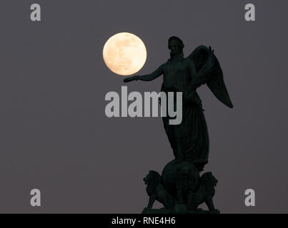 Stuttgart, Deutschland. 18 Feb, 2019. Der fast volle Mond steht in den Abendhimmel hinter der Concordia Spalte auf dem Schlossplatz. Foto: Bernd Weißbrod/dpa/Alamy leben Nachrichten Stockfoto