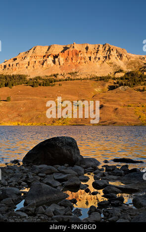 . WYOMING - Beatooth Butte glühende im frühen Morgenlicht und reflektieren in den Pfützen am Ufer des Beartooth See. Stockfoto
