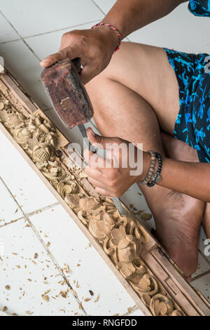 Die Hände eines Zimmermanns die traditionelle Holzschnitzerei in Bali, Indonesien. Lokale handwerkliche Tradition Konzept Stockfoto