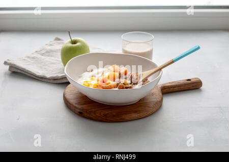 Gesundes Frühstück. Multigrain Flakes mit griechischem Joghurt, Haferflocken milch und obst Mango und Papaya Stockfoto