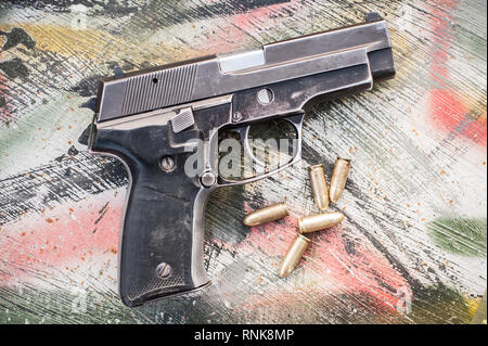 Blick von oben auf die Waffe und Munition auf dem Tisch. Schuss für Pistole in Schießstand Stockfoto