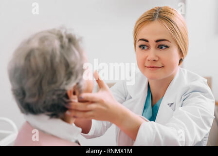 Otolaryngologist Prüfung Drüsen des Patienten bei medizinischen Büro Stockfoto