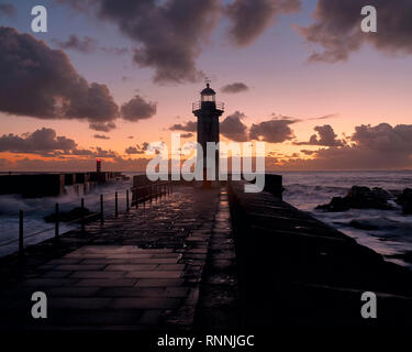 Leuchtturm am Ende der Mole in sunsethour Stockfoto