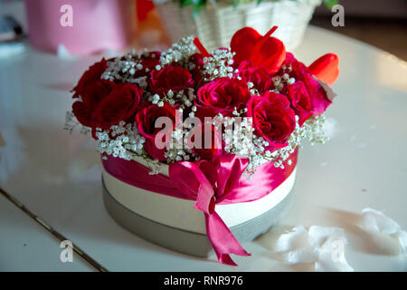 Rot und Weiß heart Bouquet. Mit einem roten Band verbunden. Handgefertigte rosa und roten Bouquet Rose In der Liebe hart-Form Valentine in Nahaufnahme. ein Feld in der Stockfoto