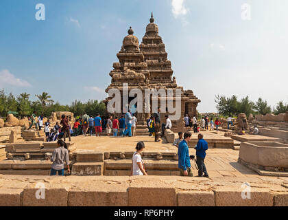 Die Shore Tempel in Mahabalipuram mit Touristen und Einheimischen besucht an einem sonnigen Tag mit blauen Himmel. Stockfoto