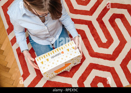 PARIS, Frankreich - Jan 5, 2018: Ansicht von oben der Neugierigen modische Frau Inspektion Karton Paket box von Zalando fashion e-commerce Company Stockfoto