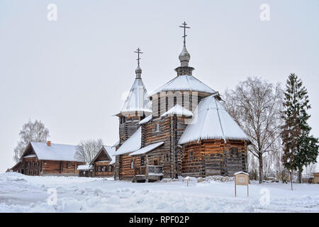 = Auferstehung Kirche und Bauernhäuser Bedeckt Schnee = Winkel Ansicht aus einer Eingangstore des Museum für Holzarchitektur auf dem Holz Kirche o Stockfoto