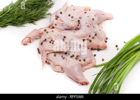 Rohes Huhn Karkasse mit Pfefferkörnern und Grün auf weißem Hintergrund Stockfoto