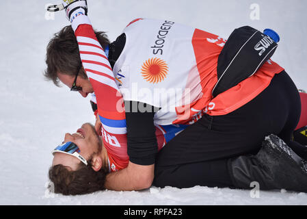 Seefeld, Österreich. 21 Feb, 2019. Gleb Retivykh Russlands erhält eine Umarmung von einem Trainer an der Ziellinie nach an dritter Stelle in der Männer 1,6-k freestyle Sprint Rennen auf dem 2019 Nordische Ski-WM. Quelle: John lazenby/Alamy leben Nachrichten Stockfoto