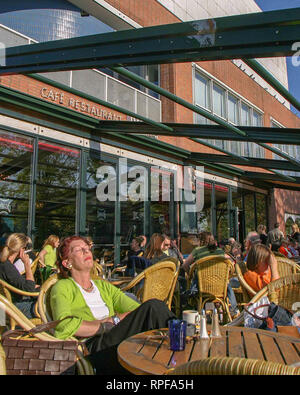 Amsterdam, Niederlande. 10.Oktober 2005. Eine Frau lehnt sich zurück etwas Sonne in einem Straßencafé in Amsterdam, die Niederlande zu erhalten. Credit: Arnold Drapkin/ZUMA Draht/Alamy leben Nachrichten Stockfoto