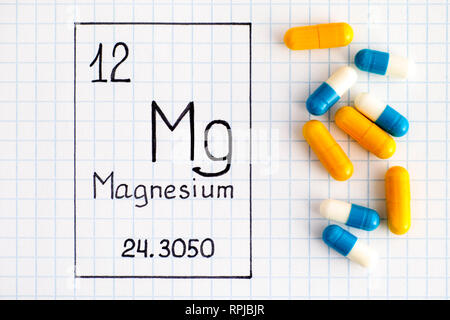 Handschrift chemische Element Magnesium Mg mit Pillen. Close-up. Stockfoto