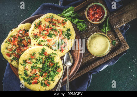 Traditionelles indisches Essen Rezepte, Hafer oder Uttapam Grieß Pfannkuchen mit frischem Gemüse und Kräutern, dunkelblauen Hintergrund Kopie Raum, Ansicht von oben Stockfoto