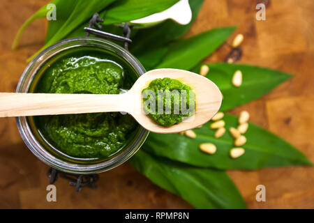 Bärlauch, Bärlauch und Sauce Pesto auf einem Holztisch Stockfoto