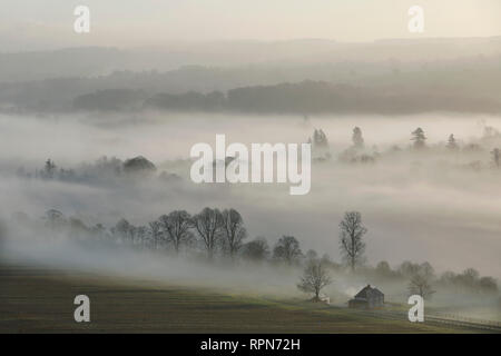 Morgennebel wirbelt um ein Bauernhaus im Meon Valley in der South Downs National Park, in der Nähe von Bishops Waltham, UK, Dienstag, 19. Februar. Photogra Stockfoto