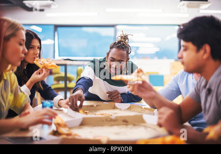 Freundlich diverse multiethnischen Business Team Essen teilen Pizza zusammen im Startup office, multirassischen Mitarbeiter Mitarbeiter Gruppe genießen Pause sprechen. l Stockfoto