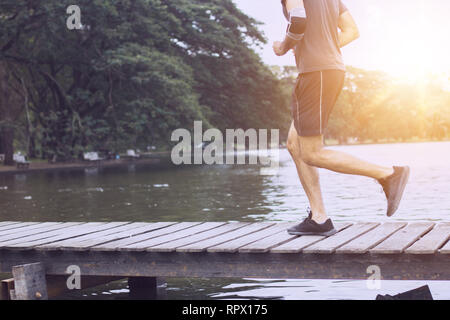 Zweiter Mann laufen auf Holz Brücke über den Kanal Stockfoto