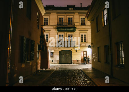Alten schmalen Nacht Vilnius Straße mit alten Architektur und Winter Hintergrund Stockfoto