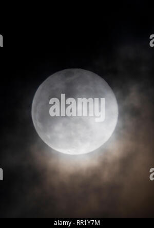 Voll super Schnee Mond steigt durch Wolken über Rocky Mountains, Salida, Colorado, USA Stockfoto