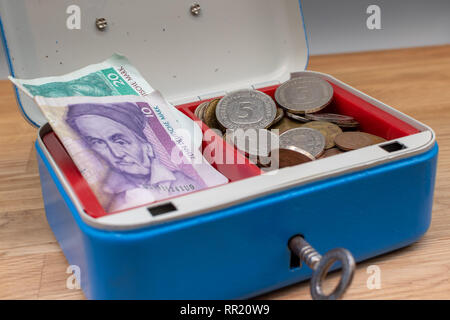 Alte Deutsche Mark Banknoten und Münzen in einem blauen Kasse gespeichert. Stockfoto