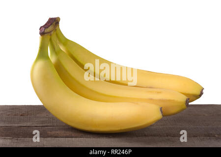 Drei Bananen auf einem Holzbrett isoliert weißer Hintergrund Stockfoto