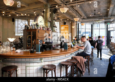 Kunden man an der Theke sitzt mit Laptop in trendigen Canova Hall italienisches Restaurant Bar Club in Brixton, London SW9 UK KATHY DEWITT Stockfoto