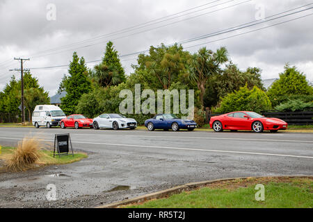 Springfield, Canterbury, Neuseeland, 24. Februar 2019: Von einer touristischen Van und Luxus Autos entlang der Landstraße außerhalb eines Cafe geparkt Stockfoto