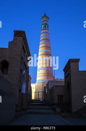 Beleuchtete Minarett des Islam Khoja in Itchan Kala am Abend, Chiwa, Usbekistan Stockfoto