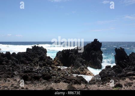 Großen, gezackten, schwarze Lava Gestein und Geröll grenzend an den Pazifischen Ozean bei laupahoehoe Point in Hawaii, USA Stockfoto