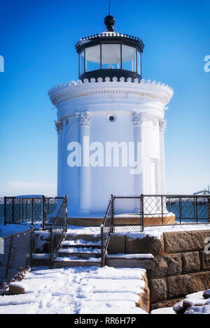 Die Portland Maine Breakwater Leuchtturm, der auch als Bug Licht, an einer kleinen Anlegestelle im Schnee an einem sonnigen blauen Himmel Winter Tag abgedeckt. Stockfoto