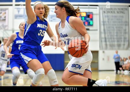 Player drivng entlang der Baseline in Richtung zum Korb und hinter einem Gegner. USA. Stockfoto