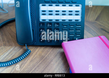 Büro Telefon auf Holz Tisch Konsole mit Notebooks Stockfoto