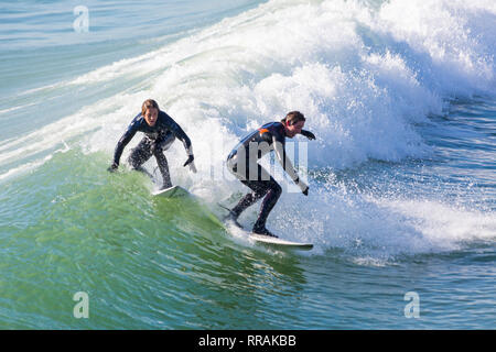 Bournemouth, Dorset, Großbritannien. 25 Feb, 2019. UK Wetter: große Wellen und viel Surfen Surfen schaffen ideale Bedingungen für Surfer am Strand von Bournemouth auf einem schönen warmen sonnigen Tag erwartet der heisseste Tag des Jahres zu sein und den heißesten Februar Tag überhaupt. Surfer auf surfbretter Reiten die Wellen. Credit: Carolyn Jenkins/Alamy leben Nachrichten Stockfoto