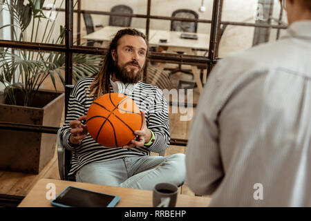 Netter Mann mit einem Basketball Ball begeistert Stockfoto