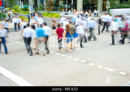 Rush Hour, Geschäftsleute gehen an Zebrastreifen in Downtown, Bewegungsunschärfe, Singapur Stockfoto