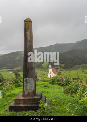 Memorial Obelisk zum Gedenken an Te Aupouri Iwi, auf der Website von Makora PA, Pawarenga, Whangape, Neuseeland. St Gabriels Kirche im Hintergrund. Stockfoto