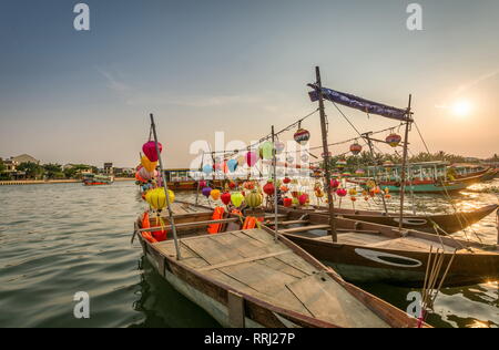 Hoi An Stadt, Boote und Flusslandschaft bei Sonnenuntergang, Vietnam Reiseziel. Vietnamesin Paddeln in einem Boot auf dem Fluss Stockfoto