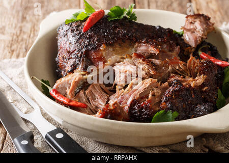 Puerto Rican Pernil asado zerkleinertem Schweinefleisch close-up auf einem Teller auf den Tisch. Horizontale Stockfoto