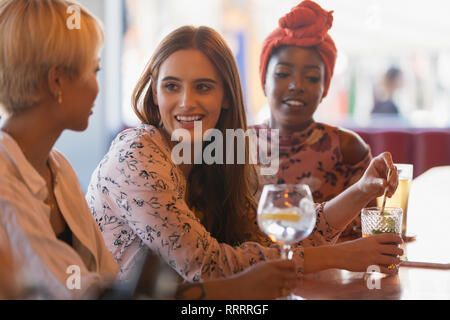 Junge Frauen, die Freunde trinken Cocktails in der Bar Stockfoto