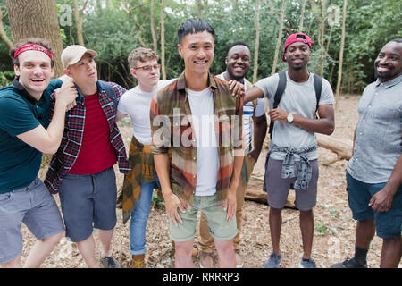 Portrait glückliche, unbeschwerte mens Gruppe wandern in Holz Stockfoto