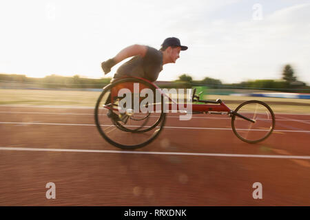 Teenager paraplegic Athlet Beschleunigung zusammen Sport Track im Rollstuhl Rennen Stockfoto