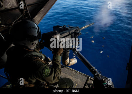 Ein U.S. Marine Corps Crew Chief mit Marine Medium Tiltrotor Squadron 363 (VMM-363), Brände eine M2 .50 Kaliber Maschinenpistole aus einer MV-22 B Osprey während Antenne schießwesen Ausbildung über den Pazifischen Ozean in der Nähe von Oahu, Hawaii, Feb 20, 2019. Die Ausbildung konzentriert sich auf die Flugzeuge Mannschaft-oberhäupter Waffen Kenntnisse der M240B medium Maschinengewehr und M2 .50 Kaliber Maschinenpistole; und Ziel Erwerb über die Kommunikation mit den Piloten über der Meeresoberfläche. (U.S. Marine Corps Foto von Sgt. Jesus Sepulveda Torres) Stockfoto