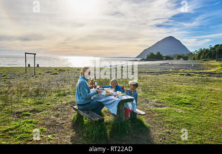 Chile Chaiten, Carretera Austral, Familie mit Picknick am Strand Stockfoto