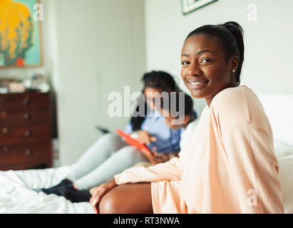 Portrait selbstbewussten jungen Frau entspannend auf Bett mit Mutter und Sohn Stockfoto