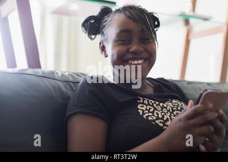 Porträt Lächeln, zuversichtlich Tween girl Texting mit smart phone Stockfoto