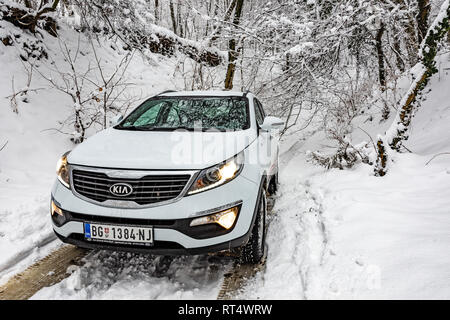 Kia Sportage 2.0 CRDI Awd oder 4x4, Farbe weiß, in einem Wald Straße, bedeckt mit Schnee und Eis. Extreme Bedingungen und Temperaturen unter -10 Stockfoto