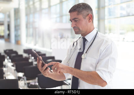 Männlicher Arzt mit digitalen Tablet in einem Konferenzraum. Stockfoto