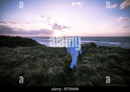 Dänemark, Nordjuetland, Mann, der Eisbär Kostüm am Strand Stockfoto